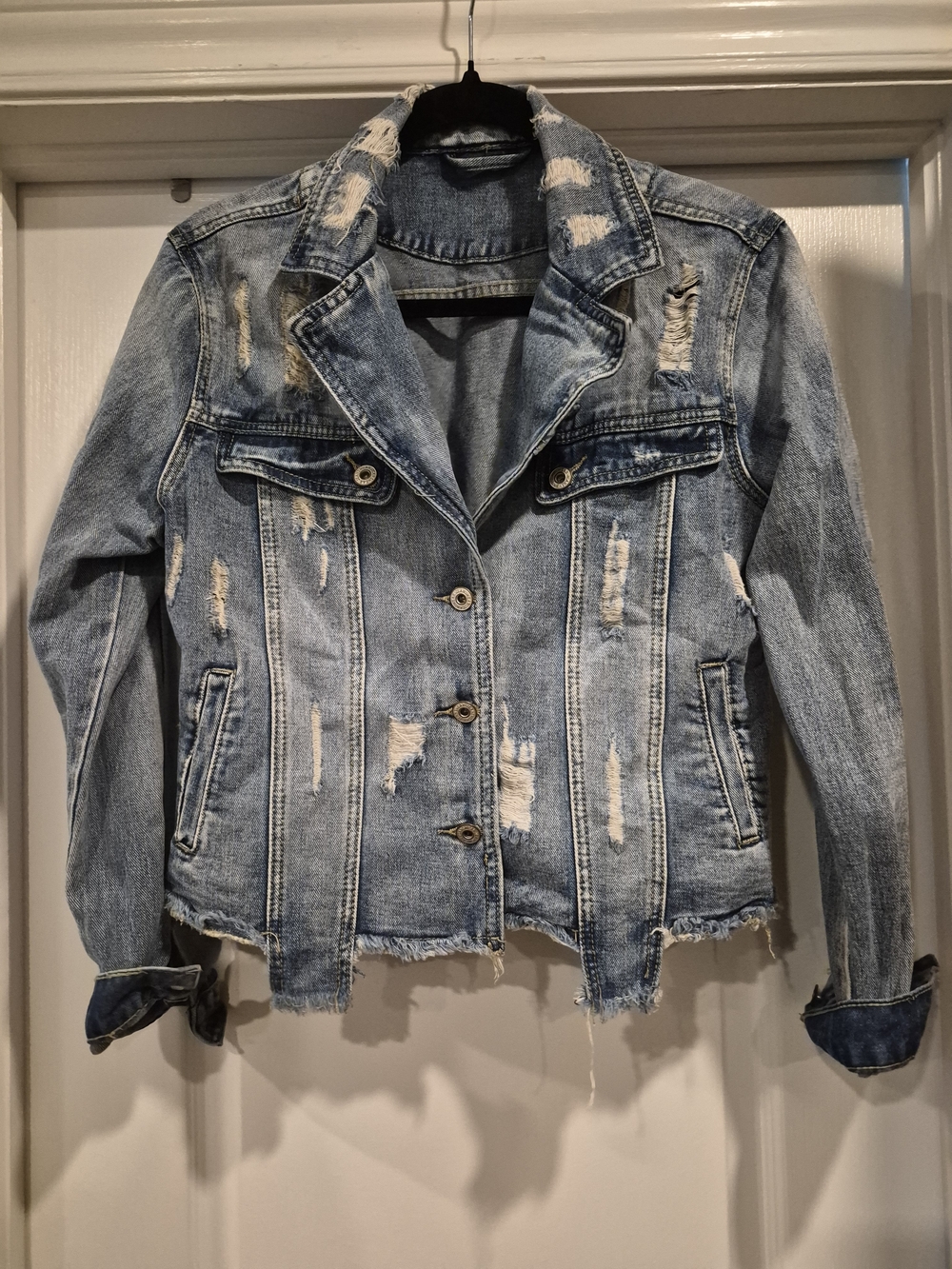 Women's Distressed Light Blue Denim Jacket.